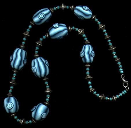 [A necklace with shaded blue beads decorated with spirals - 21K]