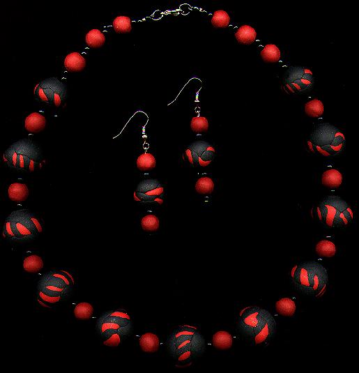 [A necklace and earrings of black beads with red-and-black candycane striping - 23K]