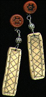 [Long earrings with crosshatched rectangular ivory pendant]