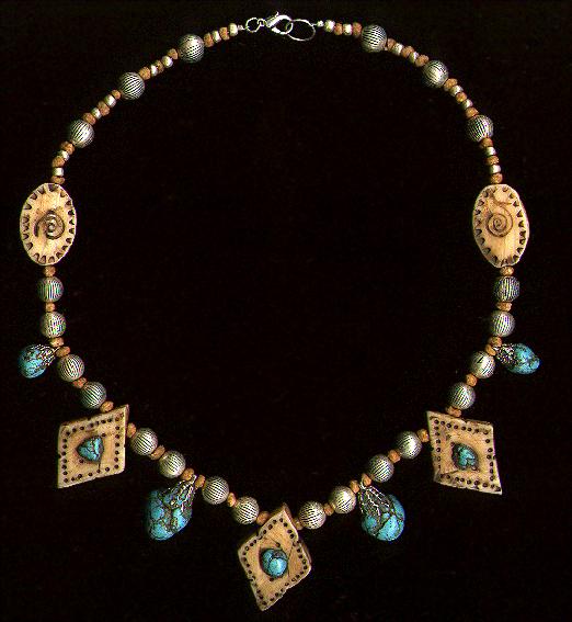 [A necklace with turquoise dangles and bits inlaid in ivory - 40K]